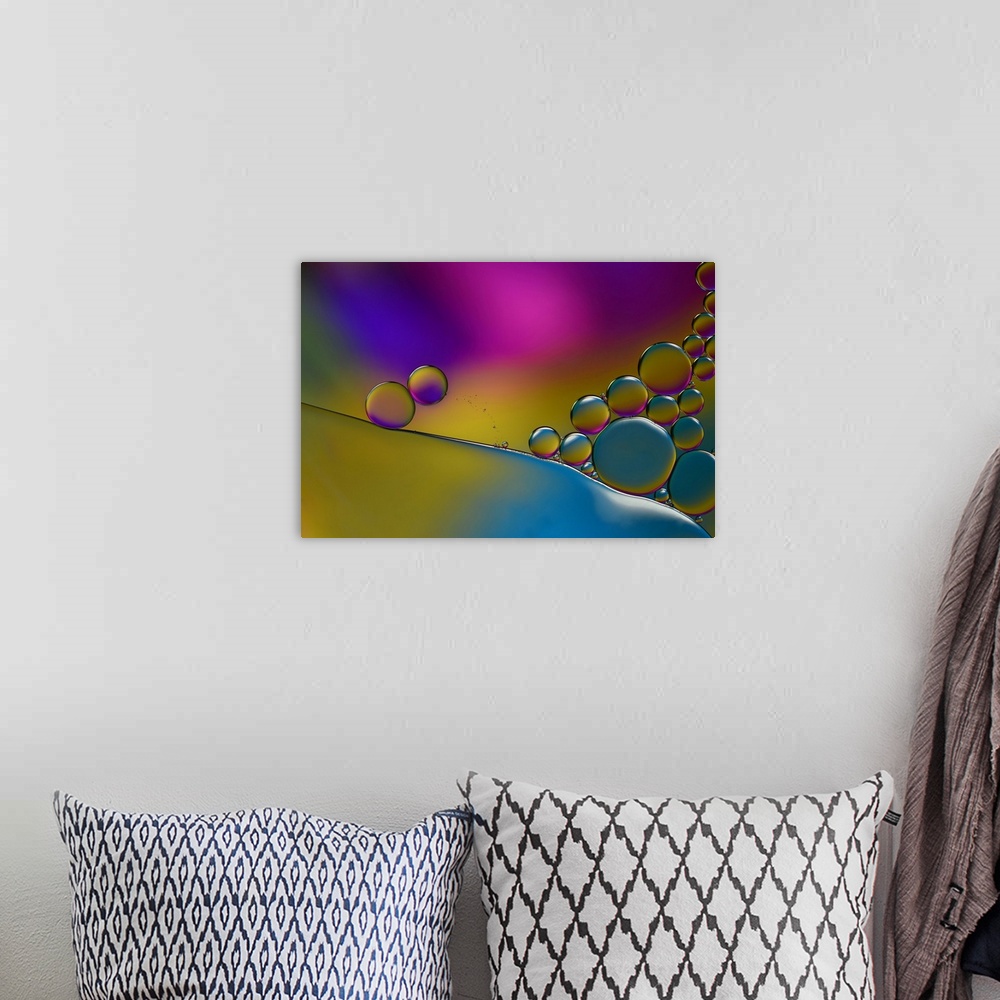 A bohemian room featuring Abstract photograph of transparent droplets stacked together with blue, yellow, pink, and purple ...