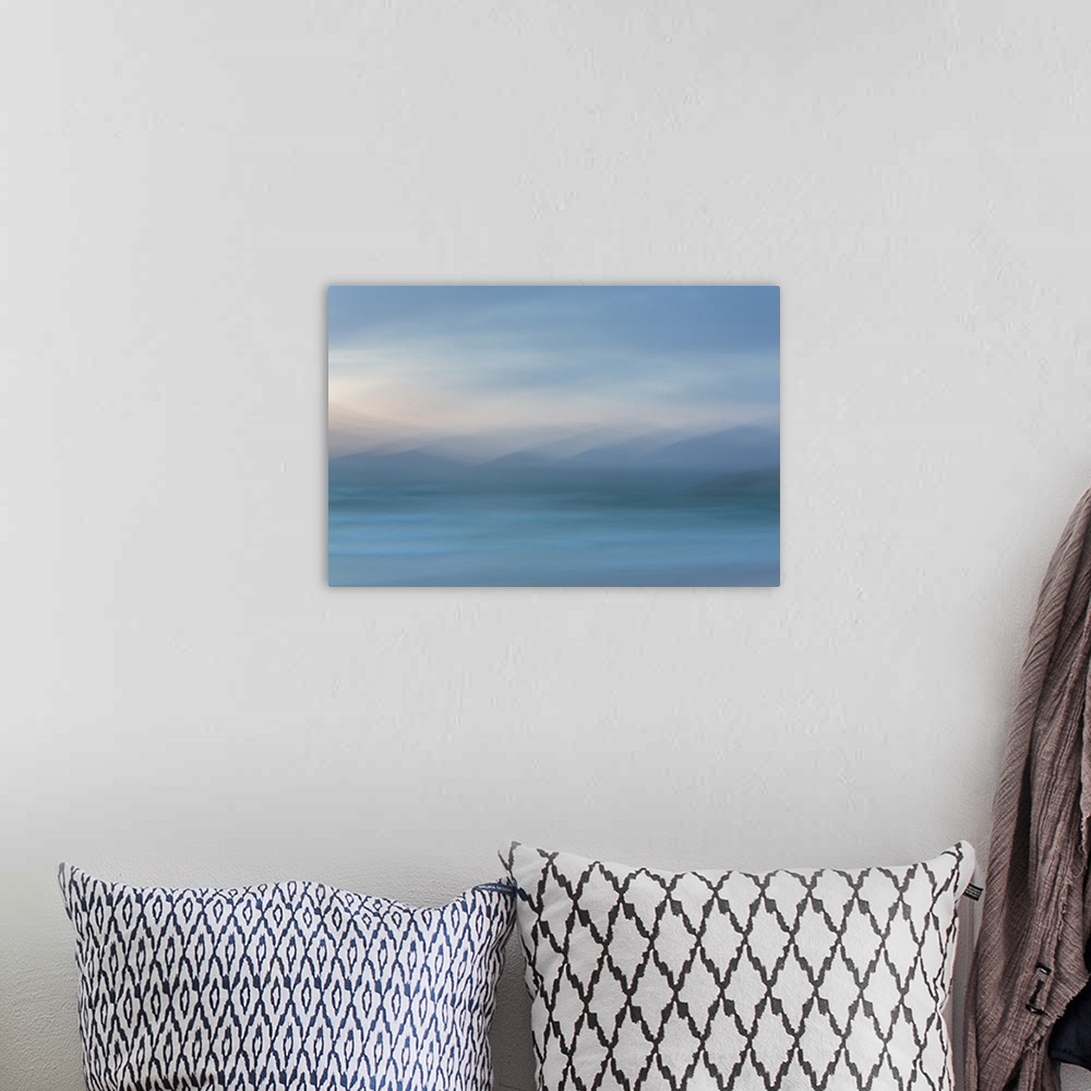 A bohemian room featuring Abstract artwork of soft blues to create an ambiguous landscape.