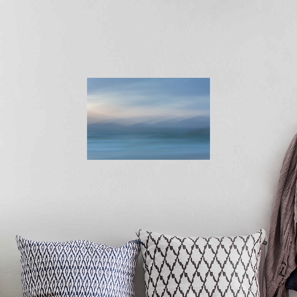 A bohemian room featuring Abstract artwork of soft blues to create an ambiguous landscape.