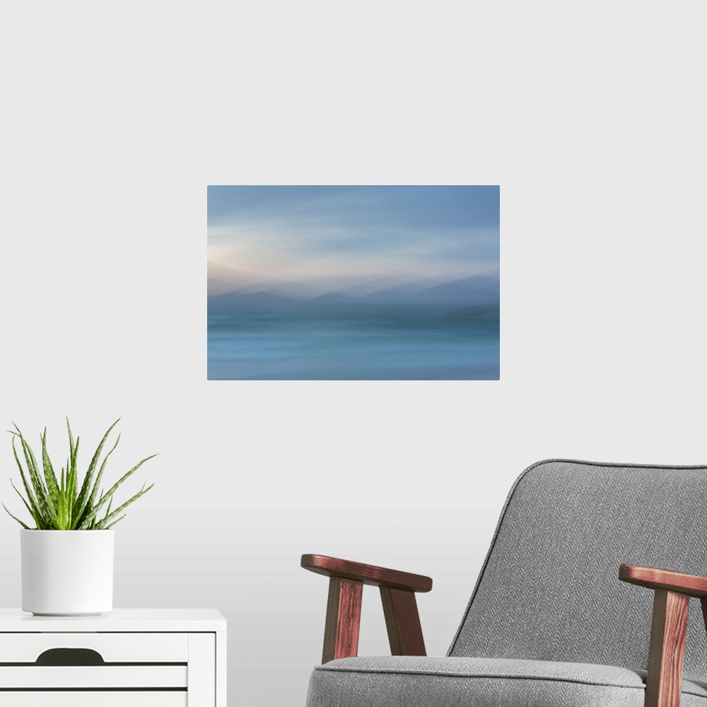 A modern room featuring Abstract artwork of soft blues to create an ambiguous landscape.