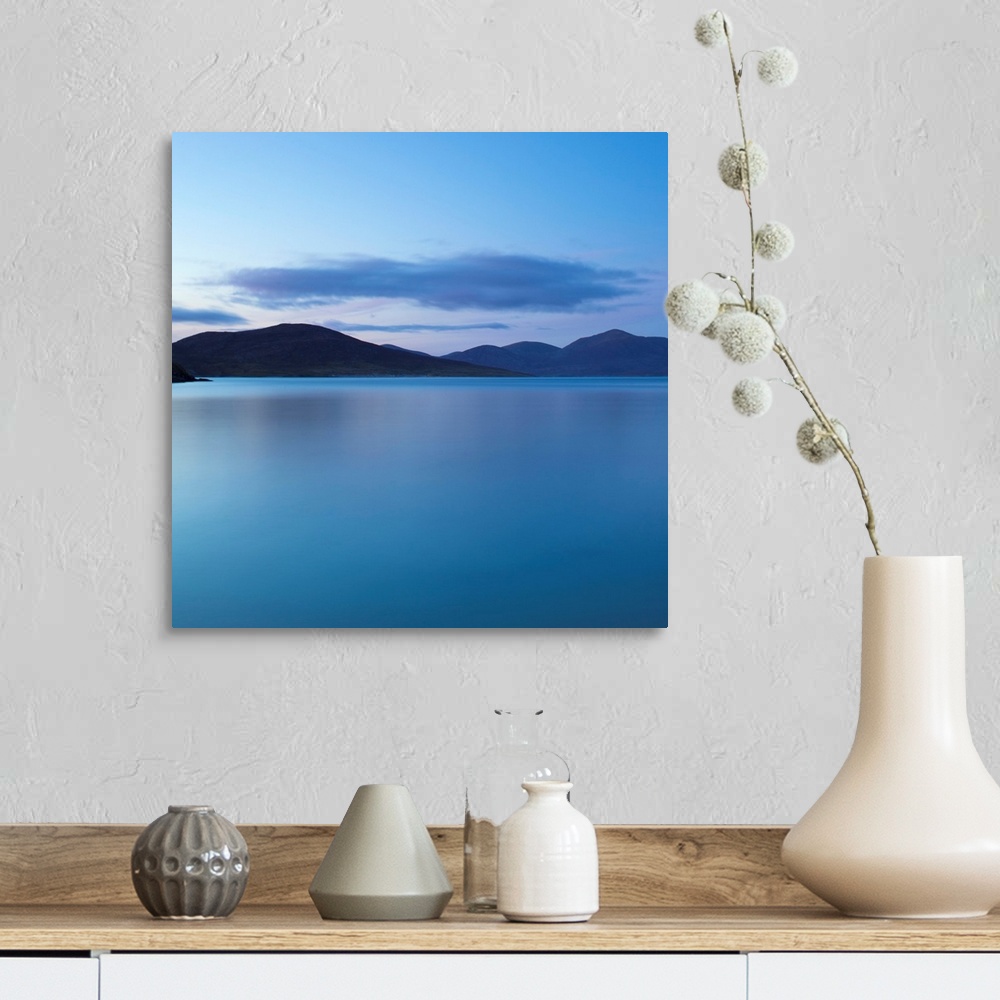 A farmhouse room featuring A cool blue minimal zen-like seascape of flat calm water with silhouetted mountains.