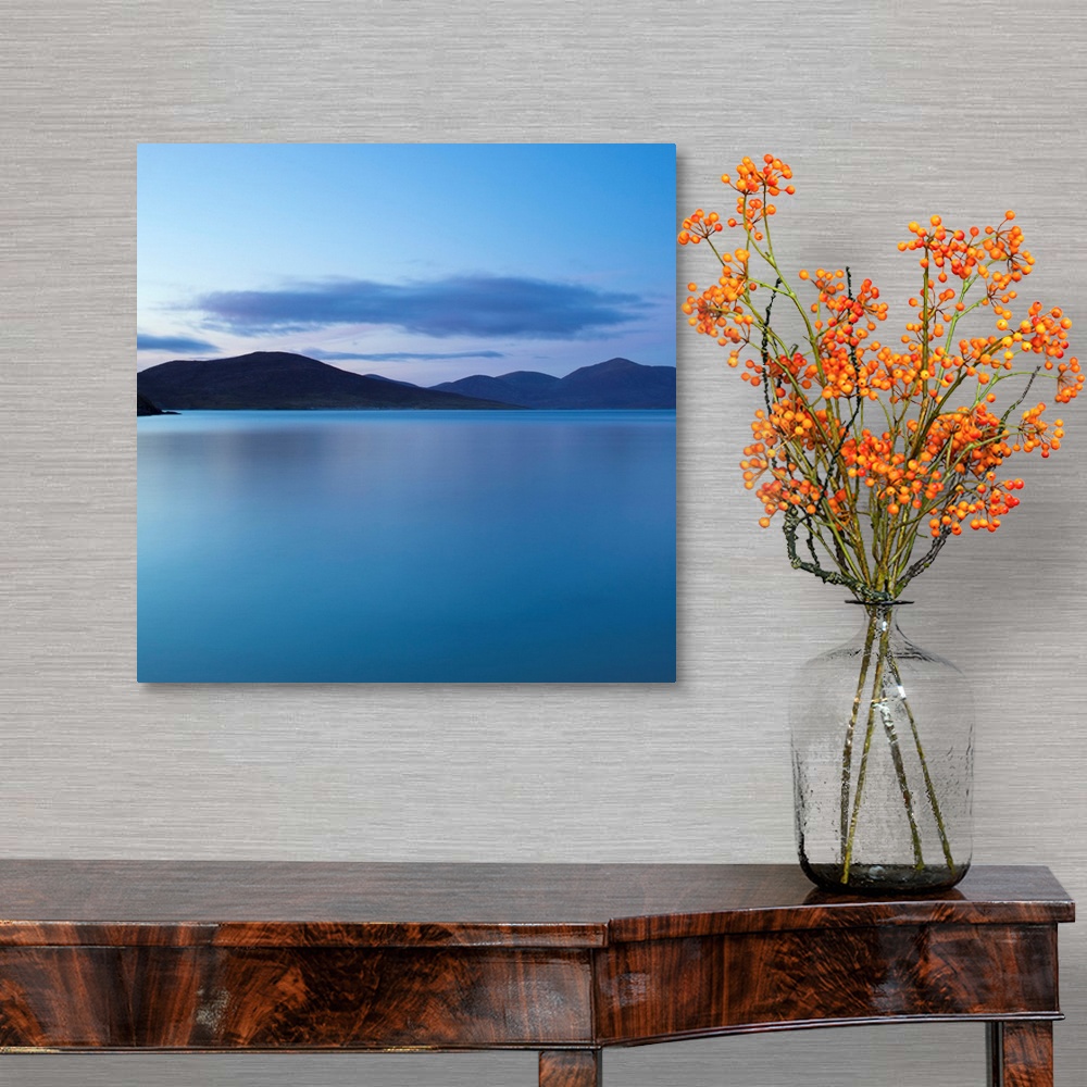 A traditional room featuring A cool blue minimal zen-like seascape of flat calm water with silhouetted mountains.