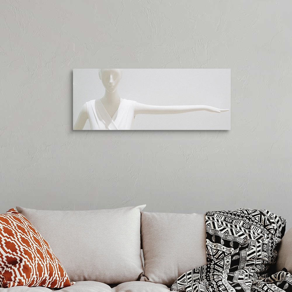 A bohemian room featuring White mannequin wearing a white outfit blending into a white background.