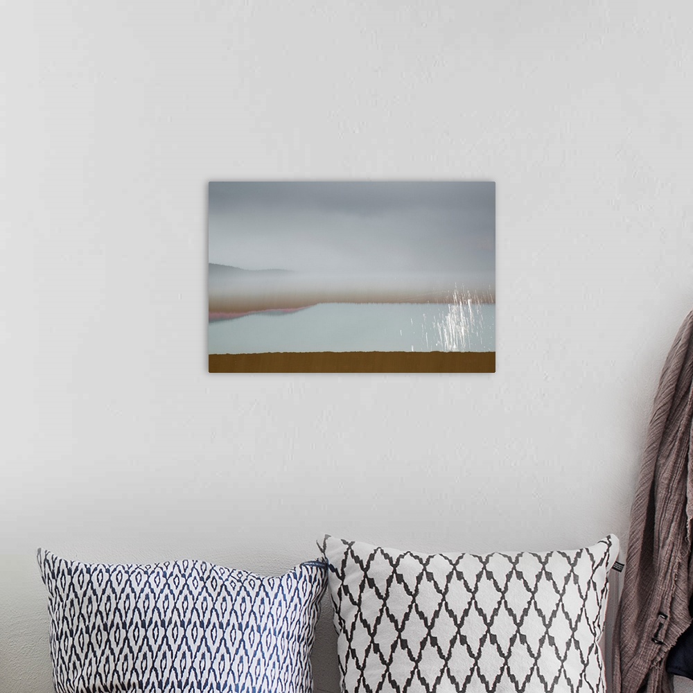 A bohemian room featuring Abstract image of a landscape with calming colors in shades of blue, brown, pink, and white.