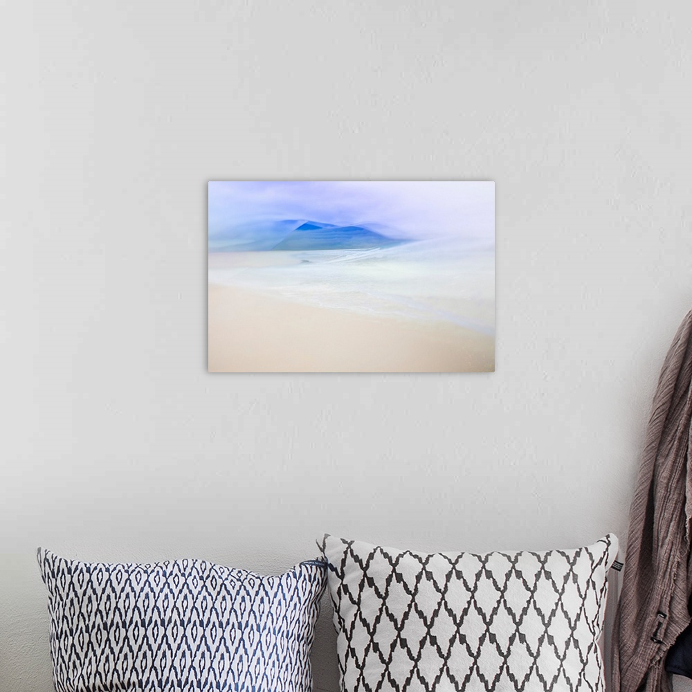 A bohemian room featuring Abstract landscape photo with the ocean faintly washing up on a sandy shore and blue silhouetted ...