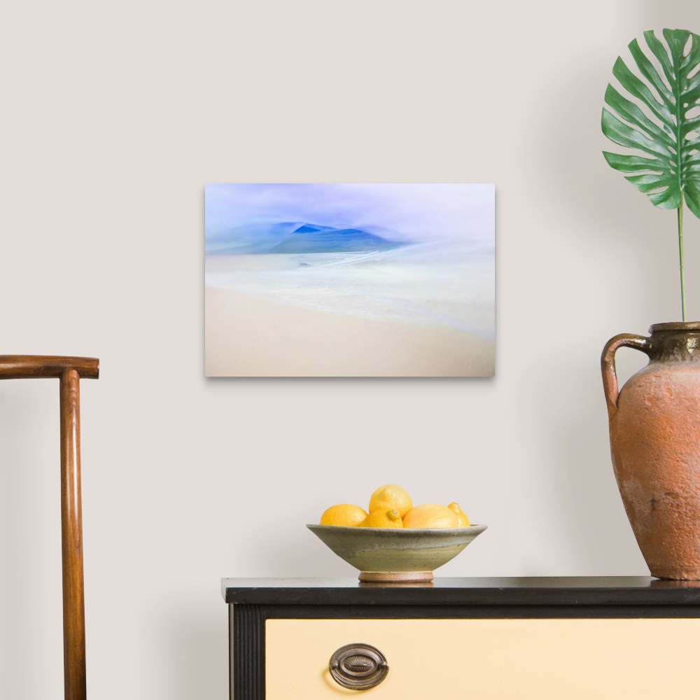 A traditional room featuring Abstract landscape photo with the ocean faintly washing up on a sandy shore and blue silhouetted ...