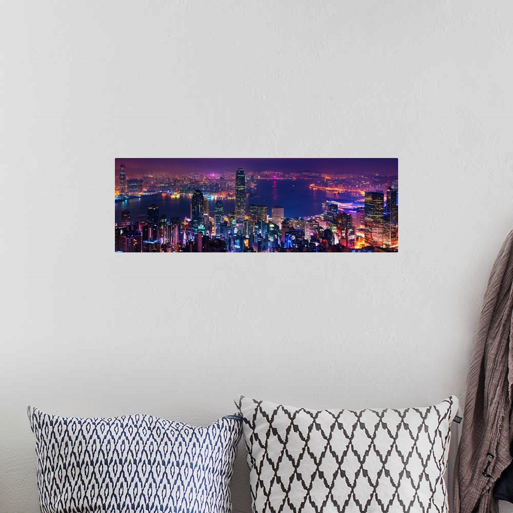 A bohemian room featuring Panoramic image of the vibrant city of Hong Kong, China at night.