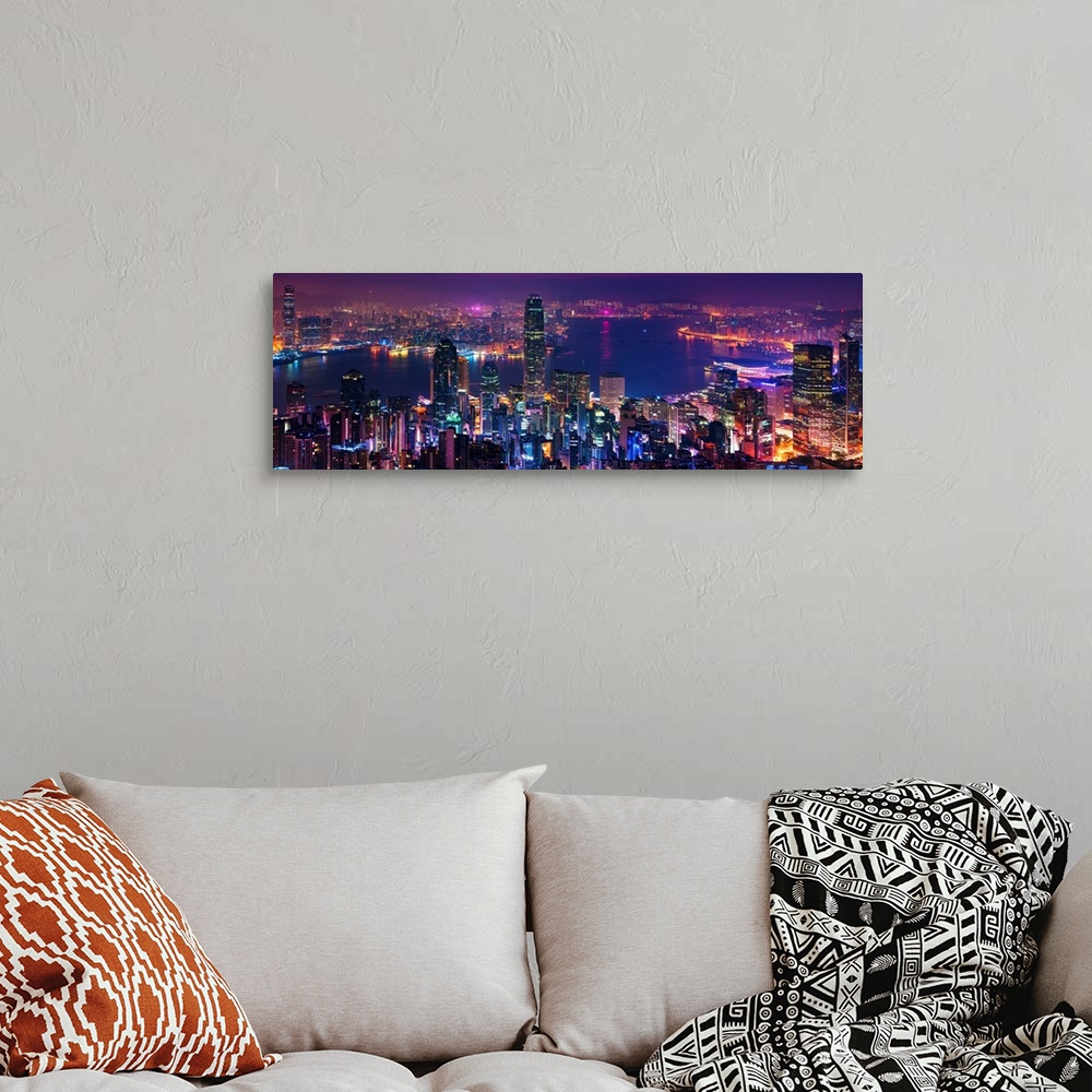 A bohemian room featuring Panoramic image of the vibrant city of Hong Kong, China at night.
