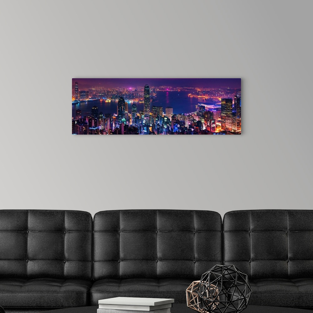 A modern room featuring Panoramic image of the vibrant city of Hong Kong, China at night.