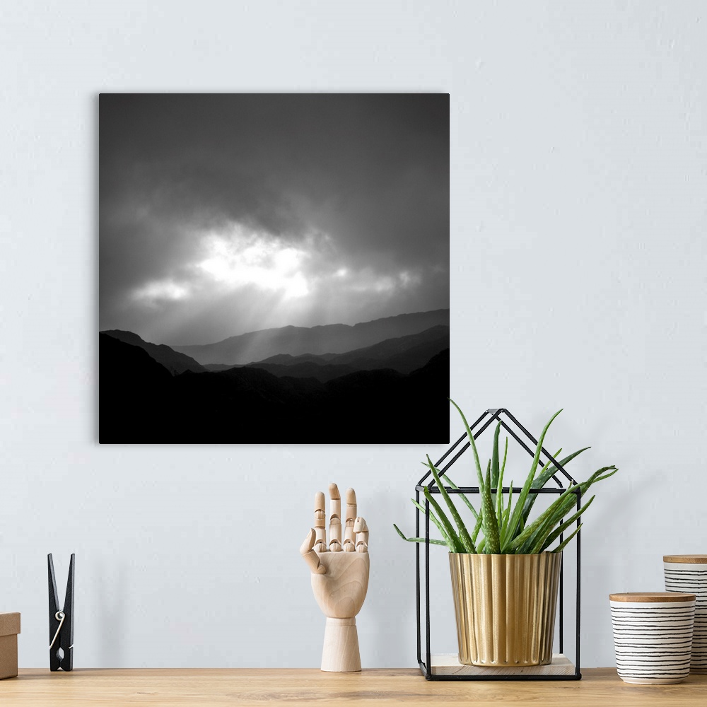 A bohemian room featuring An uplifting monochromatic image of God's Crepuscular Rays bursting through clouds over silhoutte...