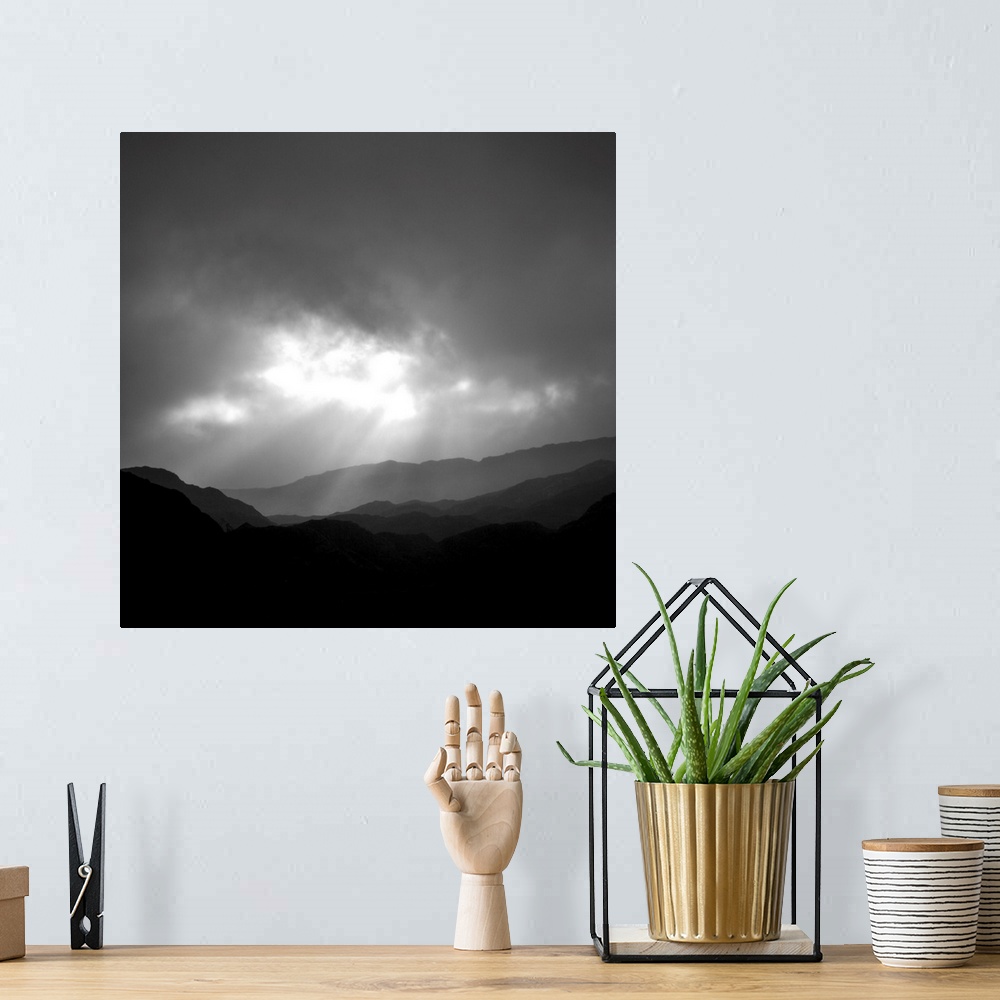 A bohemian room featuring An uplifting monochromatic image of God's Crepuscular Rays bursting through clouds over silhoutte...