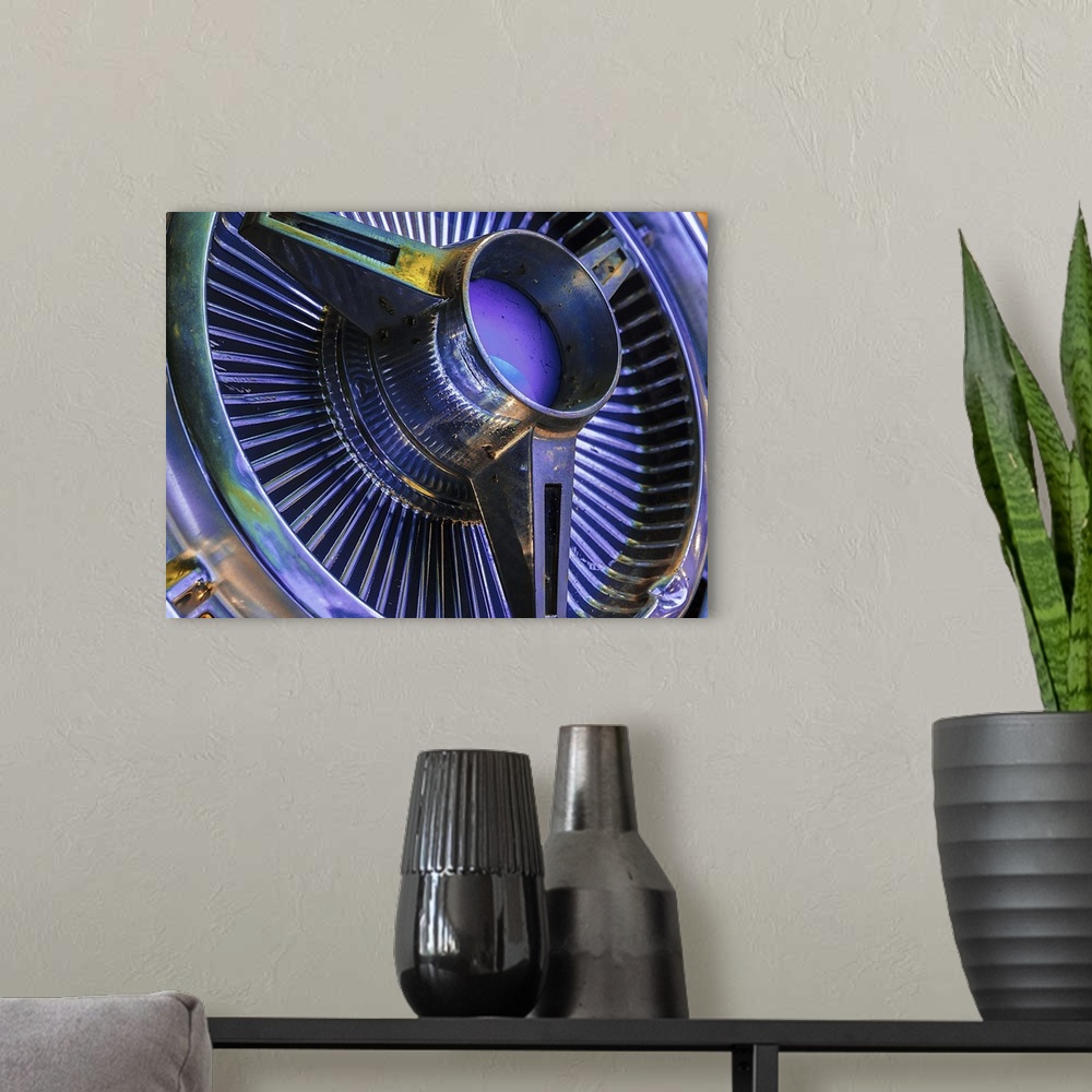 A modern room featuring Shiny chrome hubcap in vivid blue and purple hues.