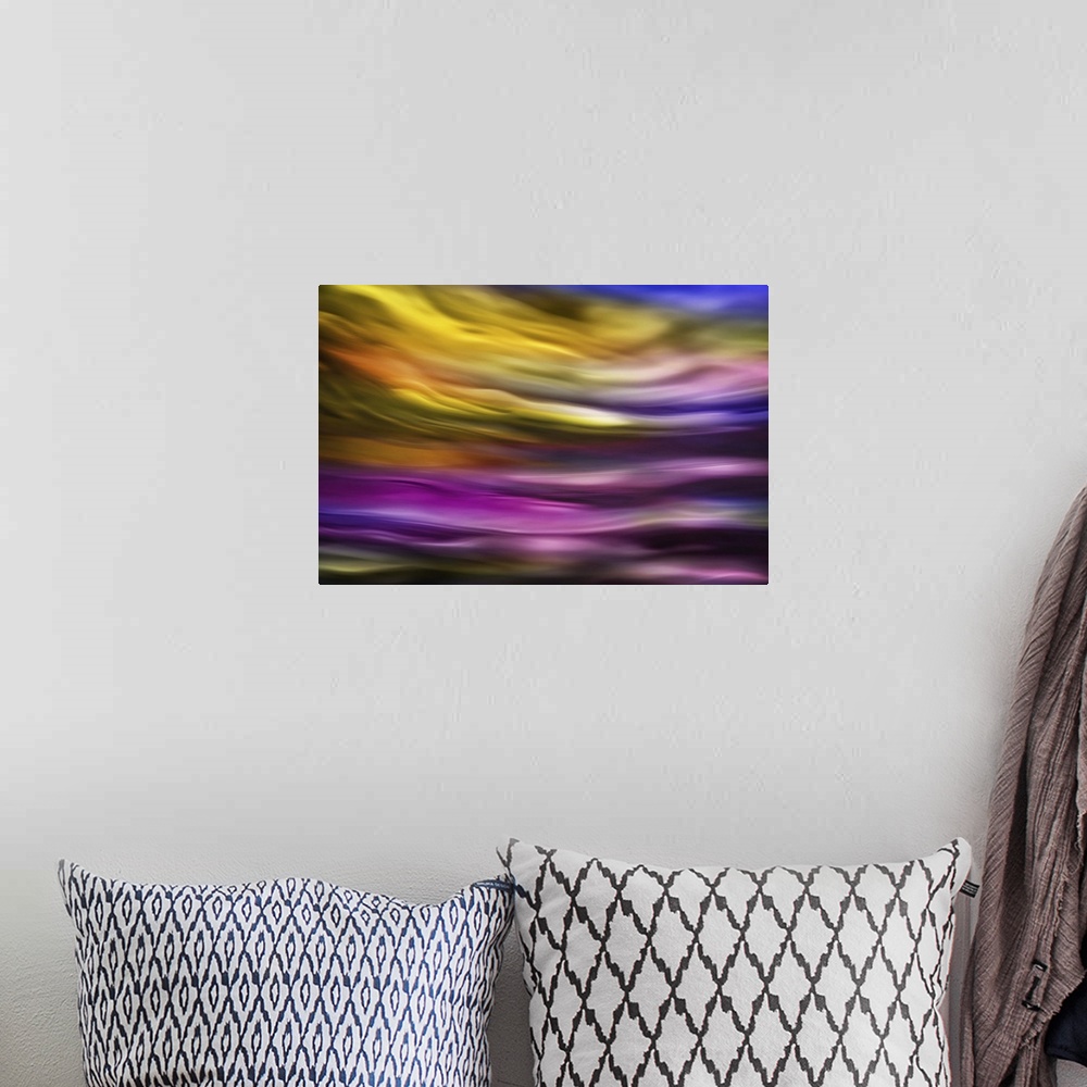 A bohemian room featuring Abstract photograph of blurred and blended colors and flowing lines in shades of purple and yellow.