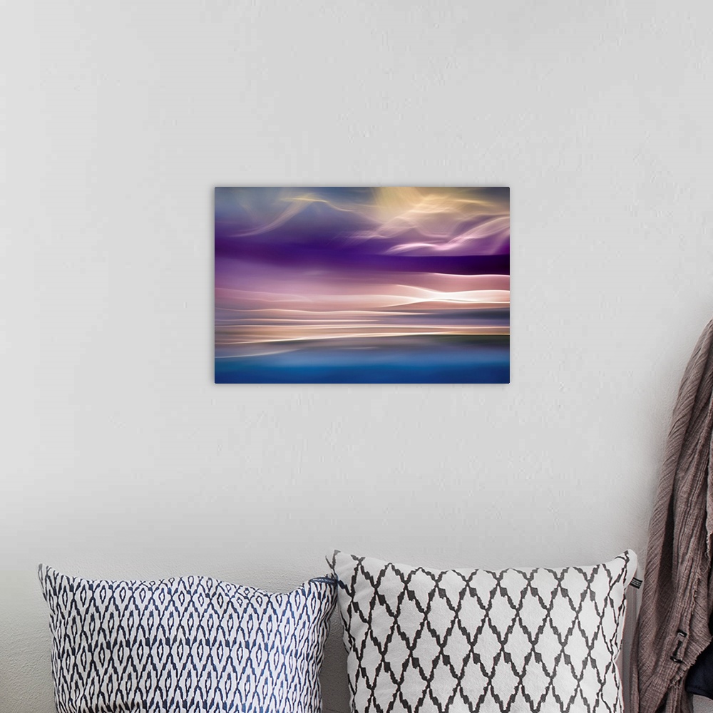A bohemian room featuring Abstract photograph with beams of light resembling mountains, in shades of pink and blue.