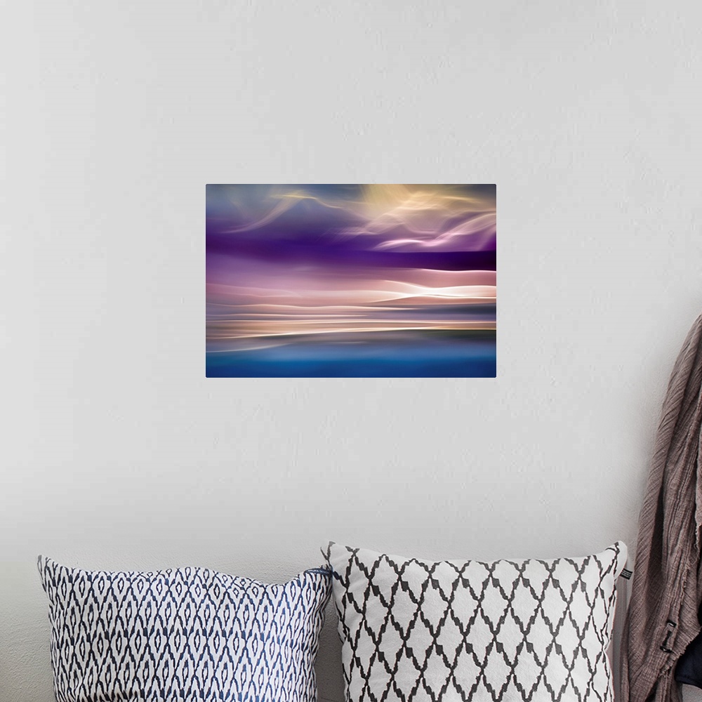 A bohemian room featuring Abstract photograph with beams of light resembling mountains, in shades of pink and blue.