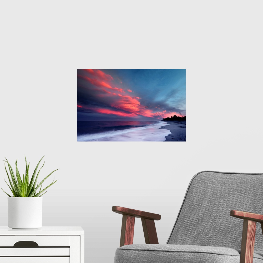 A modern room featuring Sunset over the Atlantic ocean with brilliant red clouds over white capped waves