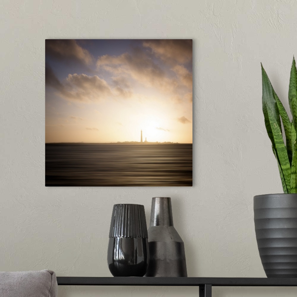 A modern room featuring Lighthouse on the horizon seen from across the ocean under a cloudy sky.