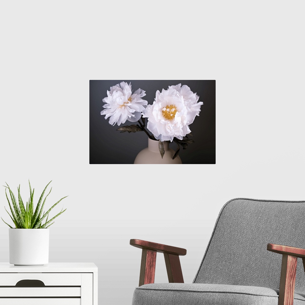 A modern room featuring White Peonies in a vase.