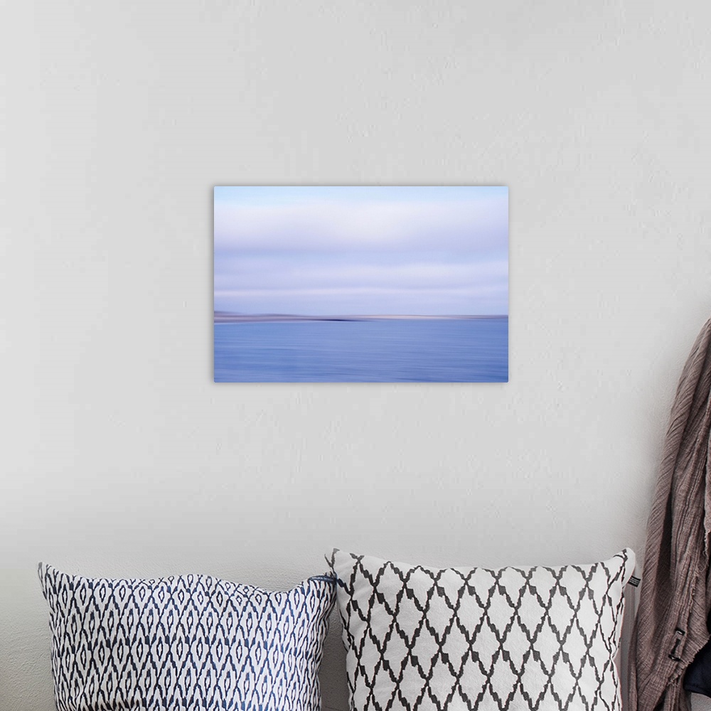 A bohemian room featuring Artistically blurred photo. View on the beach and dunes of the North Sea; land and sea in an inev...