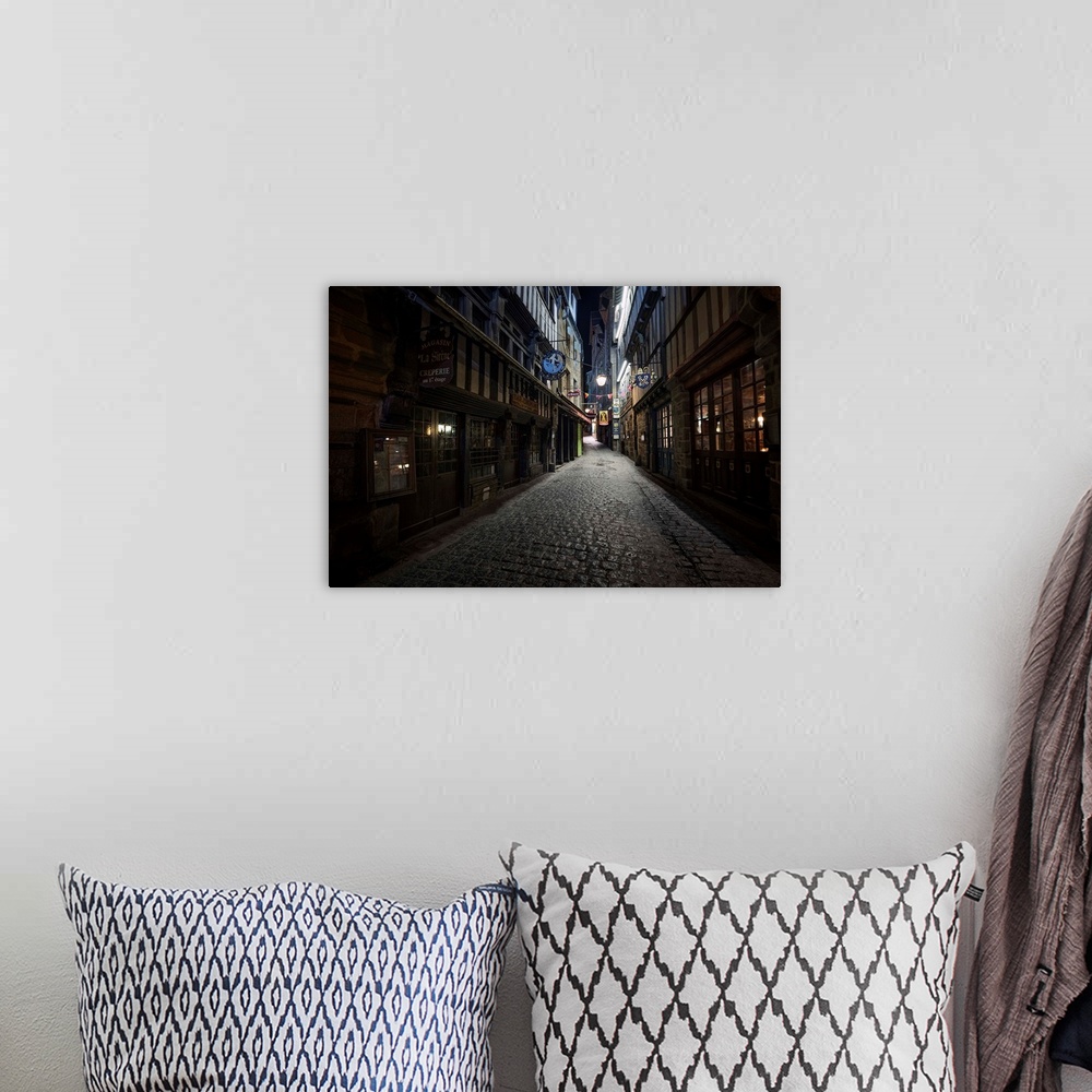 A bohemian room featuring Fine art photo of a dark alleyway with cobblestone  in France.