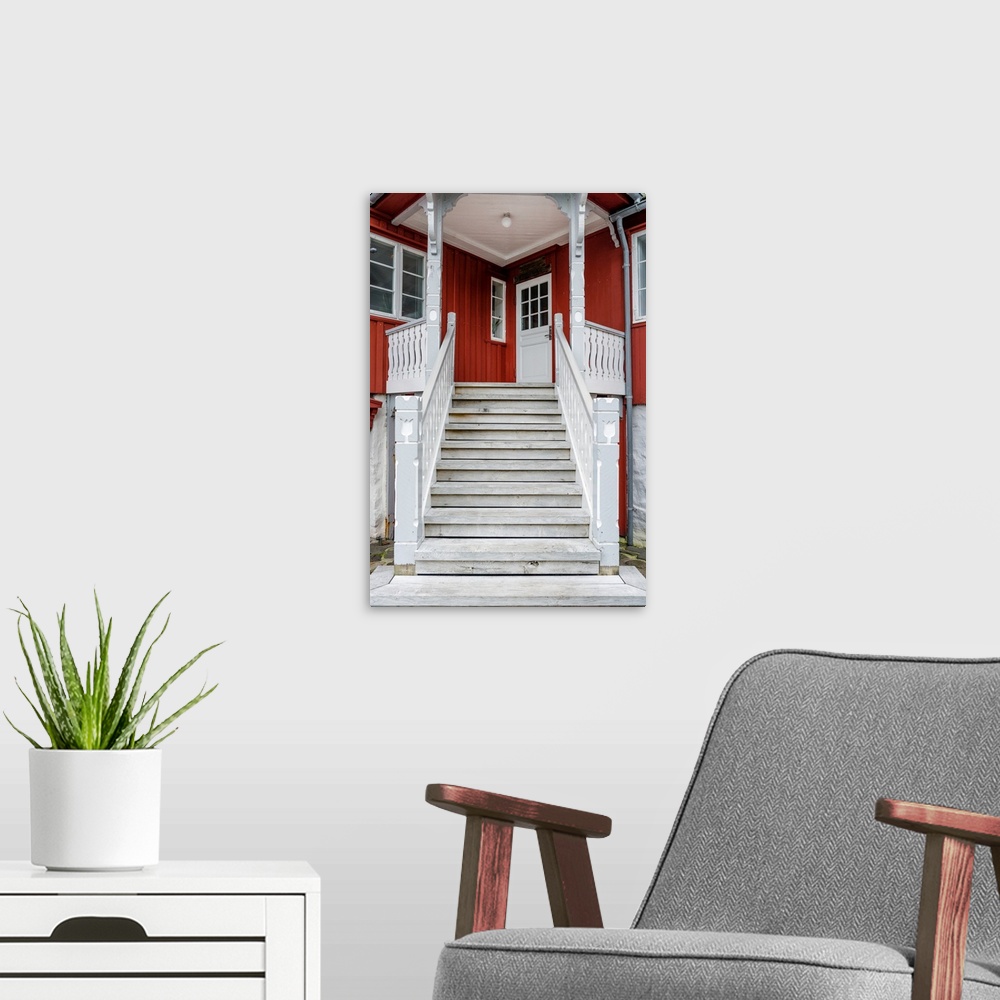 A modern room featuring Staircase leading up to the entrance of a red house.