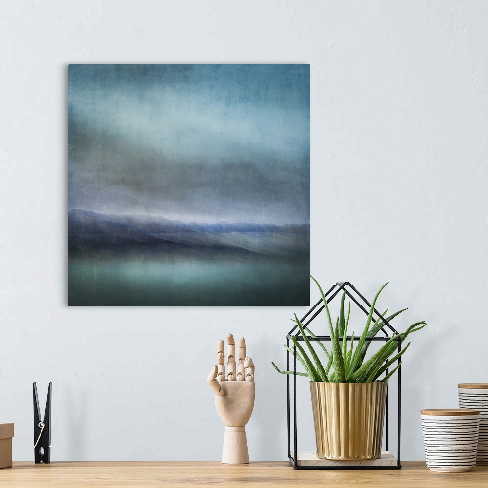 A bohemian room featuring Blue landscape abstract of tiny islands receding into the distance with moody skies and dark teal...