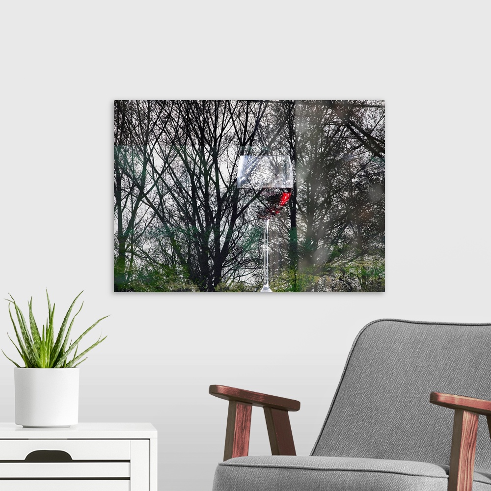 A modern room featuring Conceptual photograph of a glass of red wine blending in with silhouetted forest trees with hints...