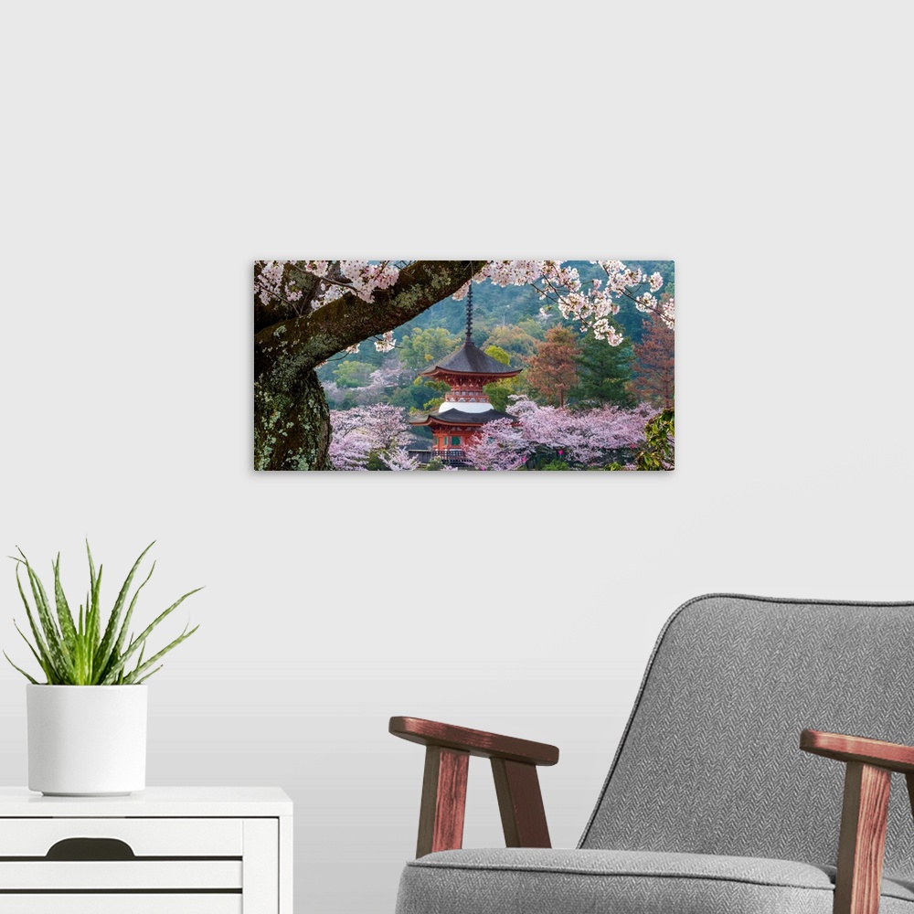 A modern room featuring Fine art photograph of a building in Japan surrounded by blossoming trees.