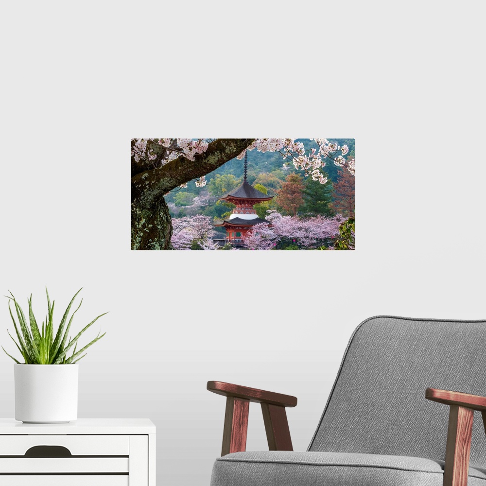 A modern room featuring Fine art photograph of a building in Japan surrounded by blossoming trees.