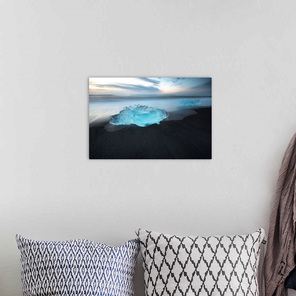 A bohemian room featuring Bright blue glacial ice on a black sand beach in Iceland.
