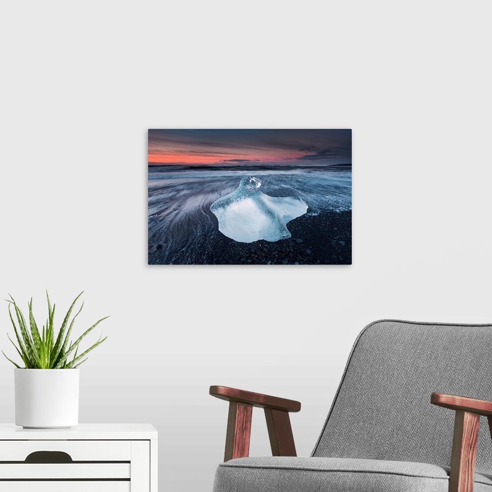 A modern room featuring One of the many icebergs on the beach near Jokulsarlon, Iceland, captured during sunrise.