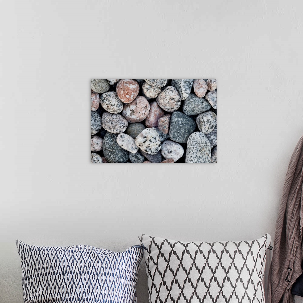 A bohemian room featuring A close up of pale contemporary granite pebbles on a beach.