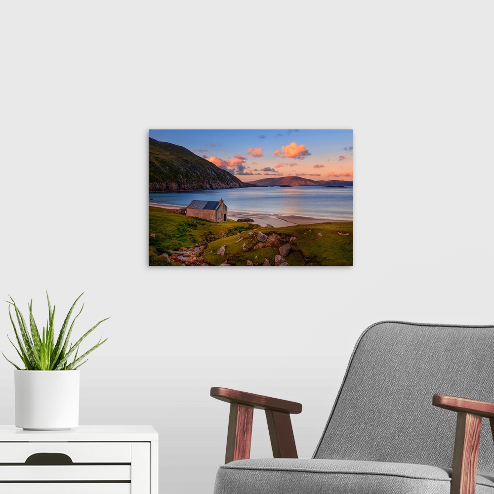 A modern room featuring Peaceful scene of a sunset on an Irish beach