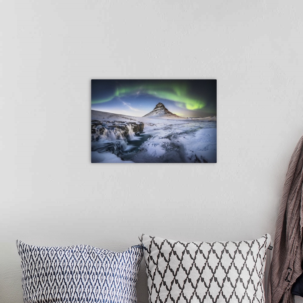 A bohemian room featuring Waterfall and field below Kirkjufell in Iceland, with a green aurora borealis above.