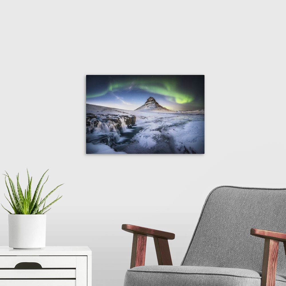 A modern room featuring Waterfall and field below Kirkjufell in Iceland, with a green aurora borealis above.