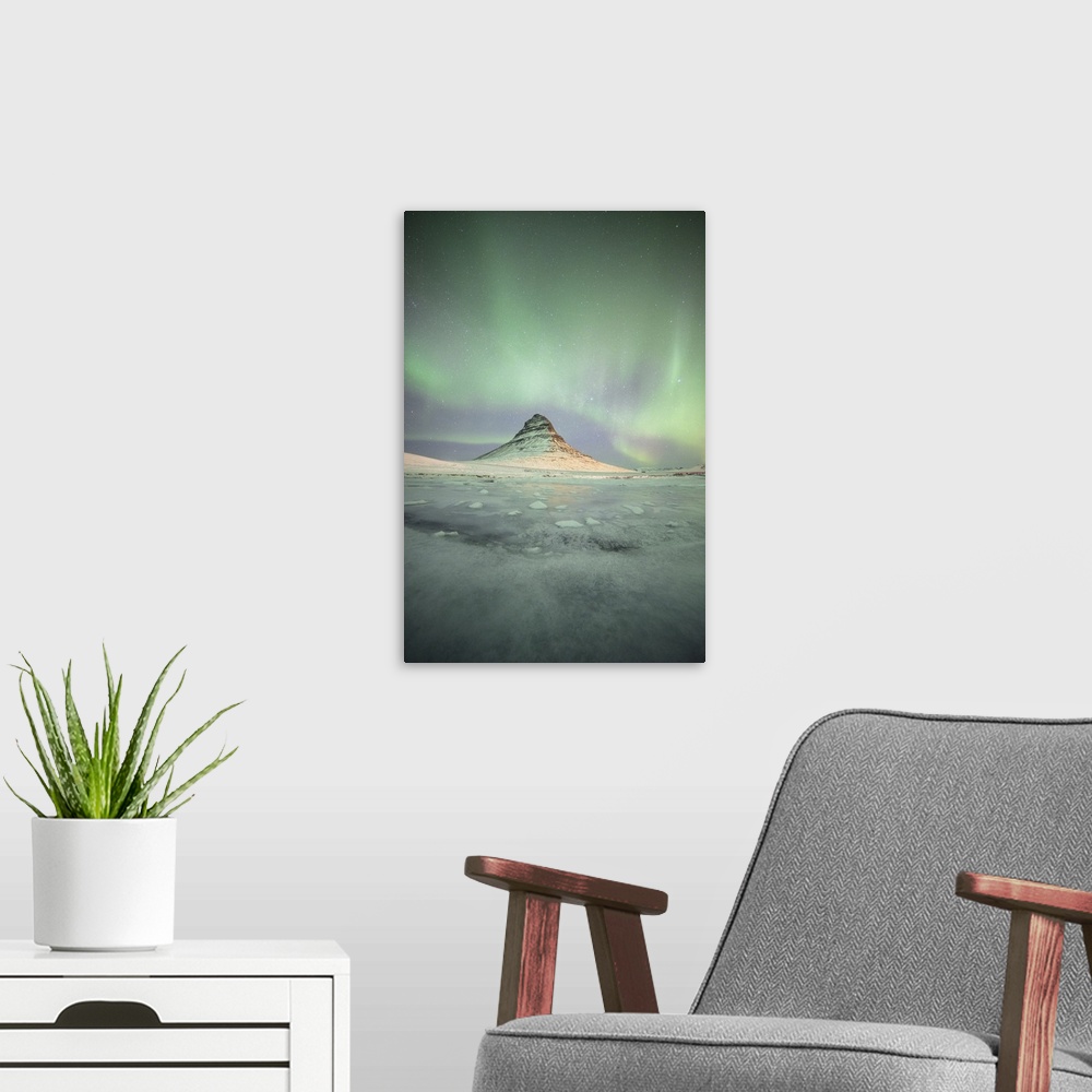 A modern room featuring Stunning northern lights in the sky illuminating Kirkjufell in Iceland at night.
