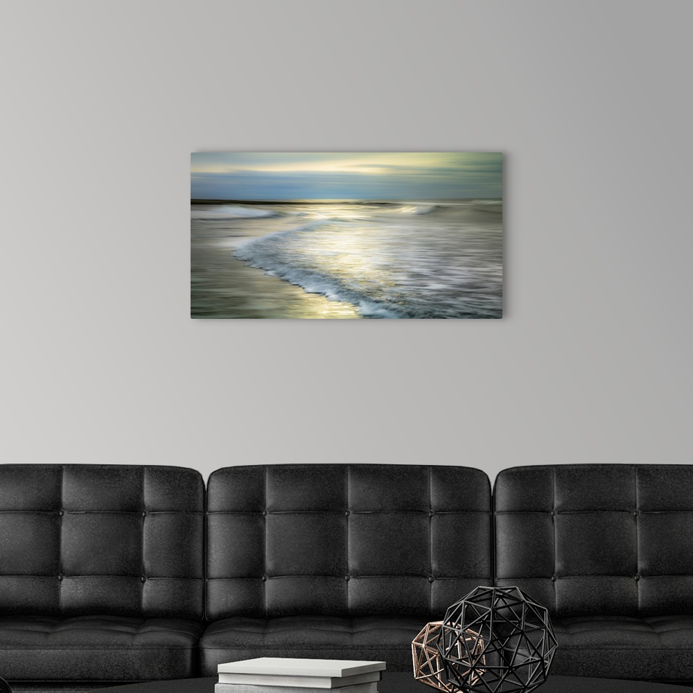 A modern room featuring A creative long exposure of the waves on the beach.