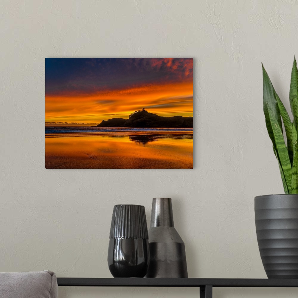 A modern room featuring Silhouetted sea stacks off the Oregon coast under a stunning orange sunset.
