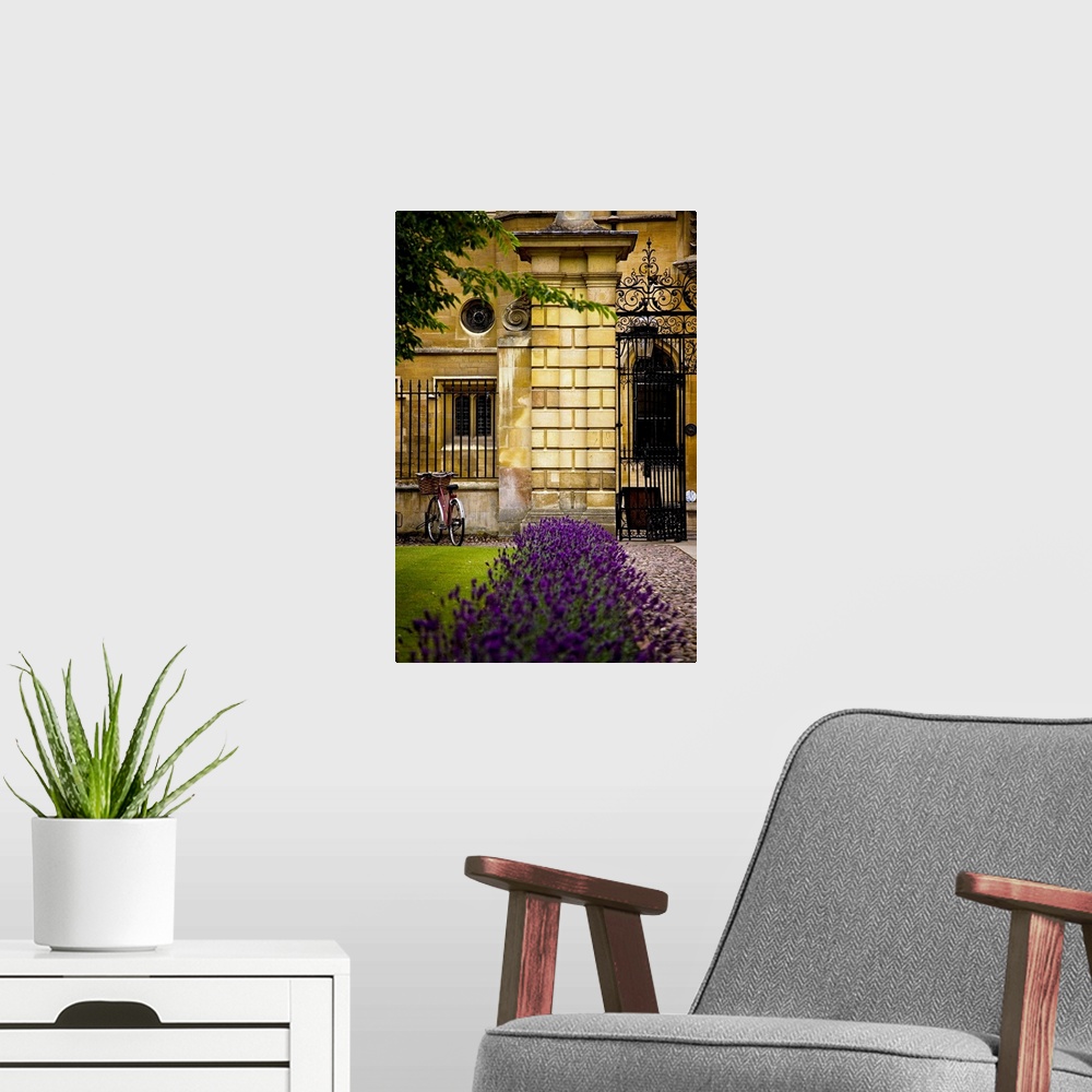 A modern room featuring Huge photograph outside of a stone and wrought iron fence containing a large brick building in En...