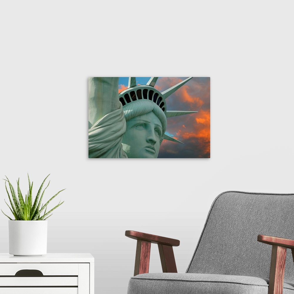A modern room featuring Artistic photograph of the face and crown of the Statue of Liberty in New York with a stunning su...