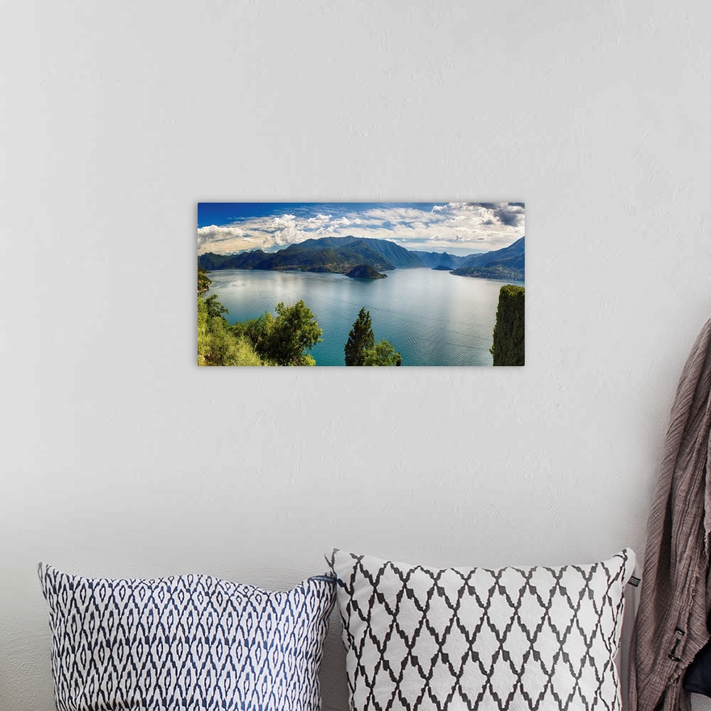 A bohemian room featuring Fine art photo of Lake Como in Italy with mountains in the distance under a cloudy sky.