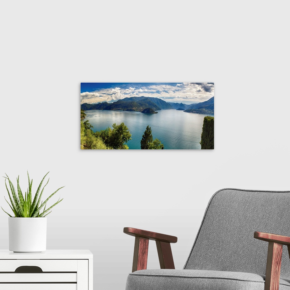 A modern room featuring Fine art photo of Lake Como in Italy with mountains in the distance under a cloudy sky.