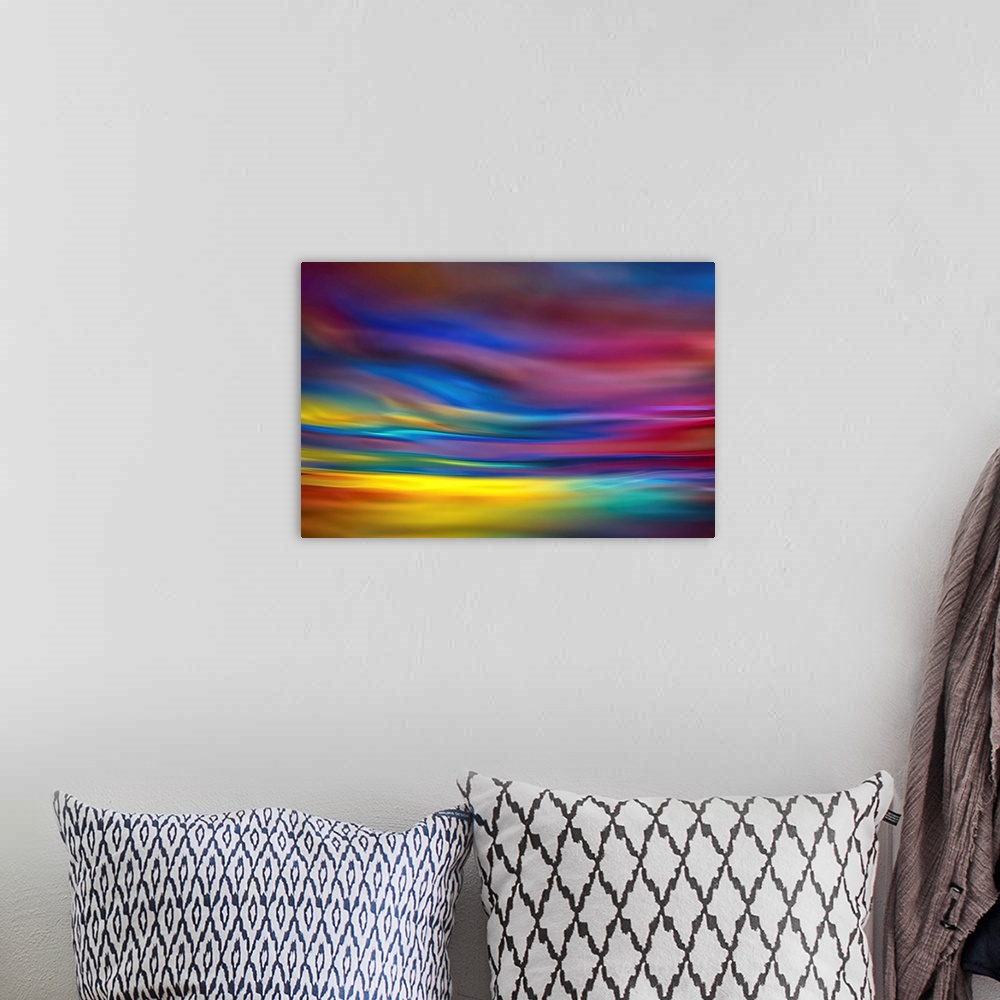 A bohemian room featuring Abstract art with colorful waves of color running horizontally across the canvas in a dreamlike way.
