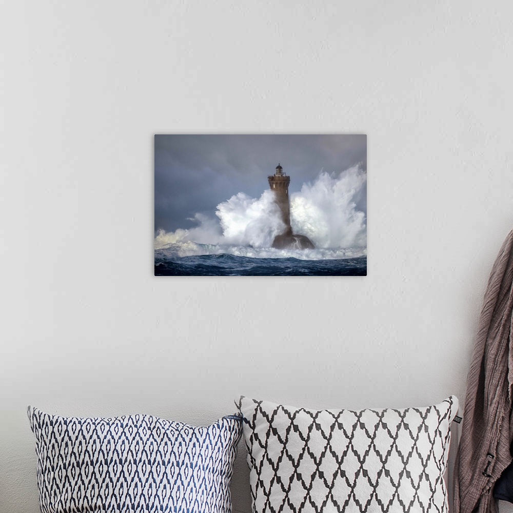 A bohemian room featuring Large wave crashing onto a lighthouse in France.