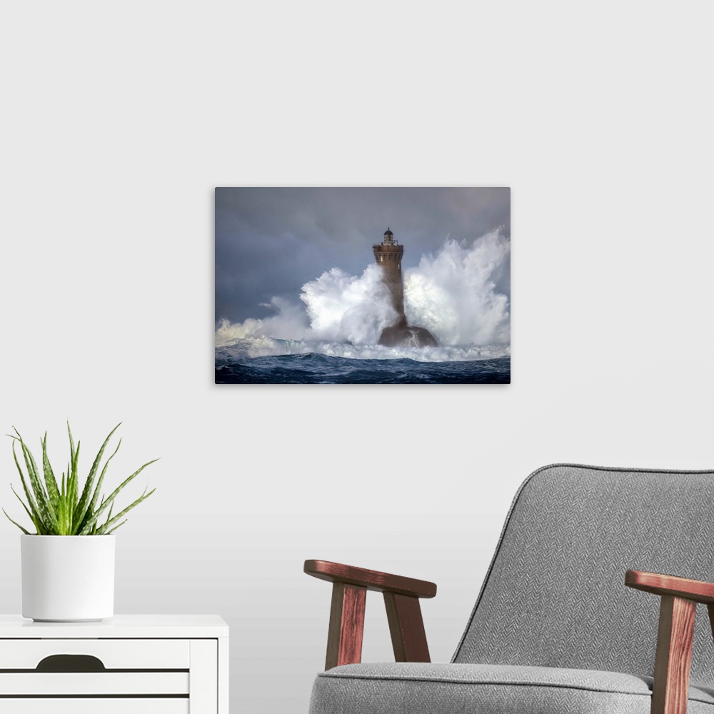 A modern room featuring Large wave crashing onto a lighthouse in France.