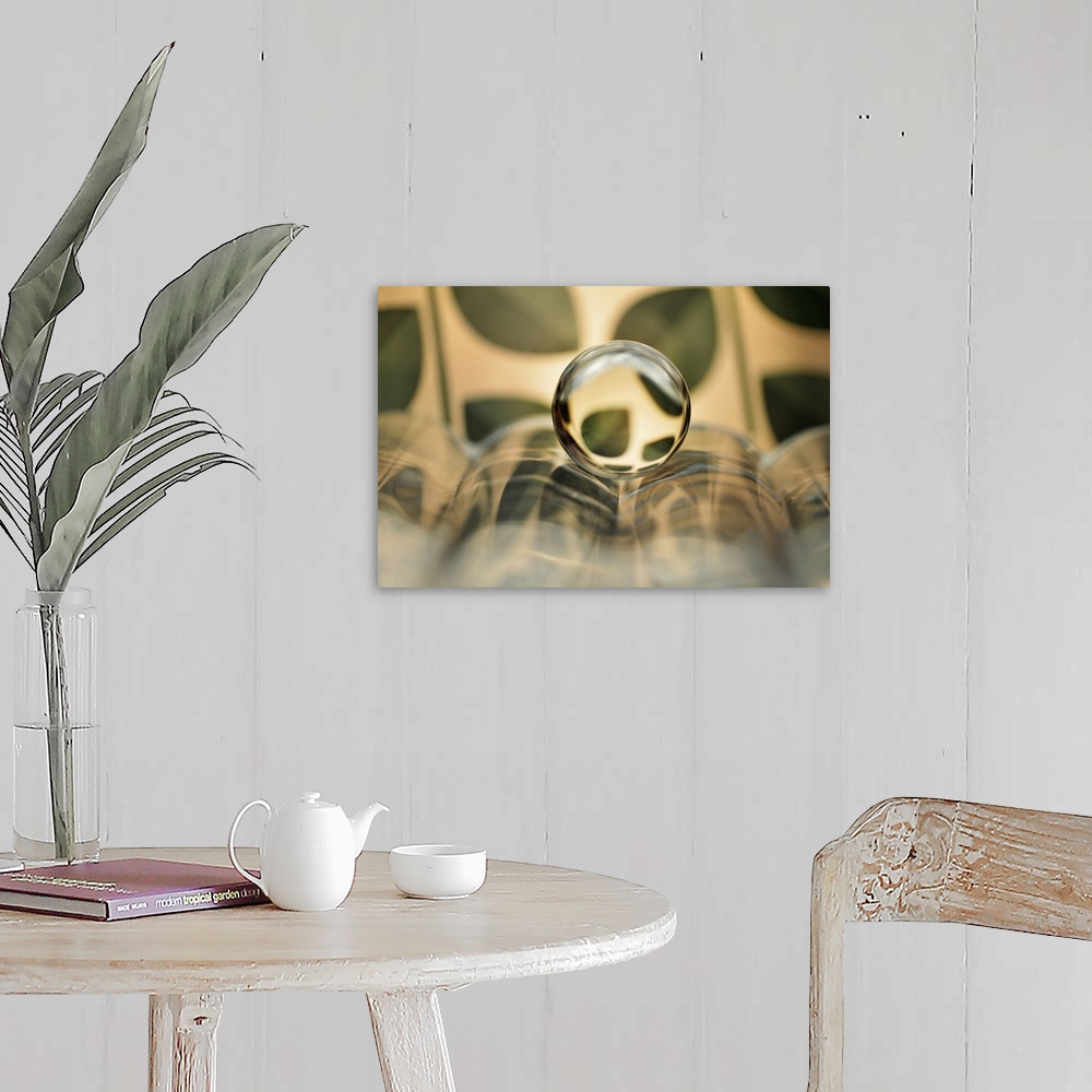 A farmhouse room featuring A photograph of a glass orb in an abstracted landscape.