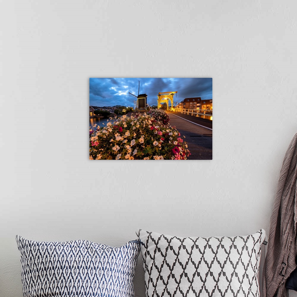 A bohemian room featuring Drawbridge and windmill at night with blooming flowers, Leiden, South Holland, Netherlands.