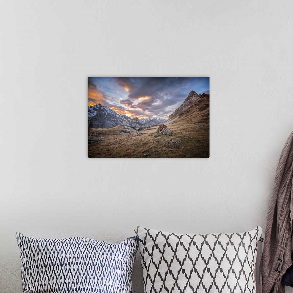 A bohemian room featuring Fine art photograph of an alpine landscape with colorful clouds overhead.