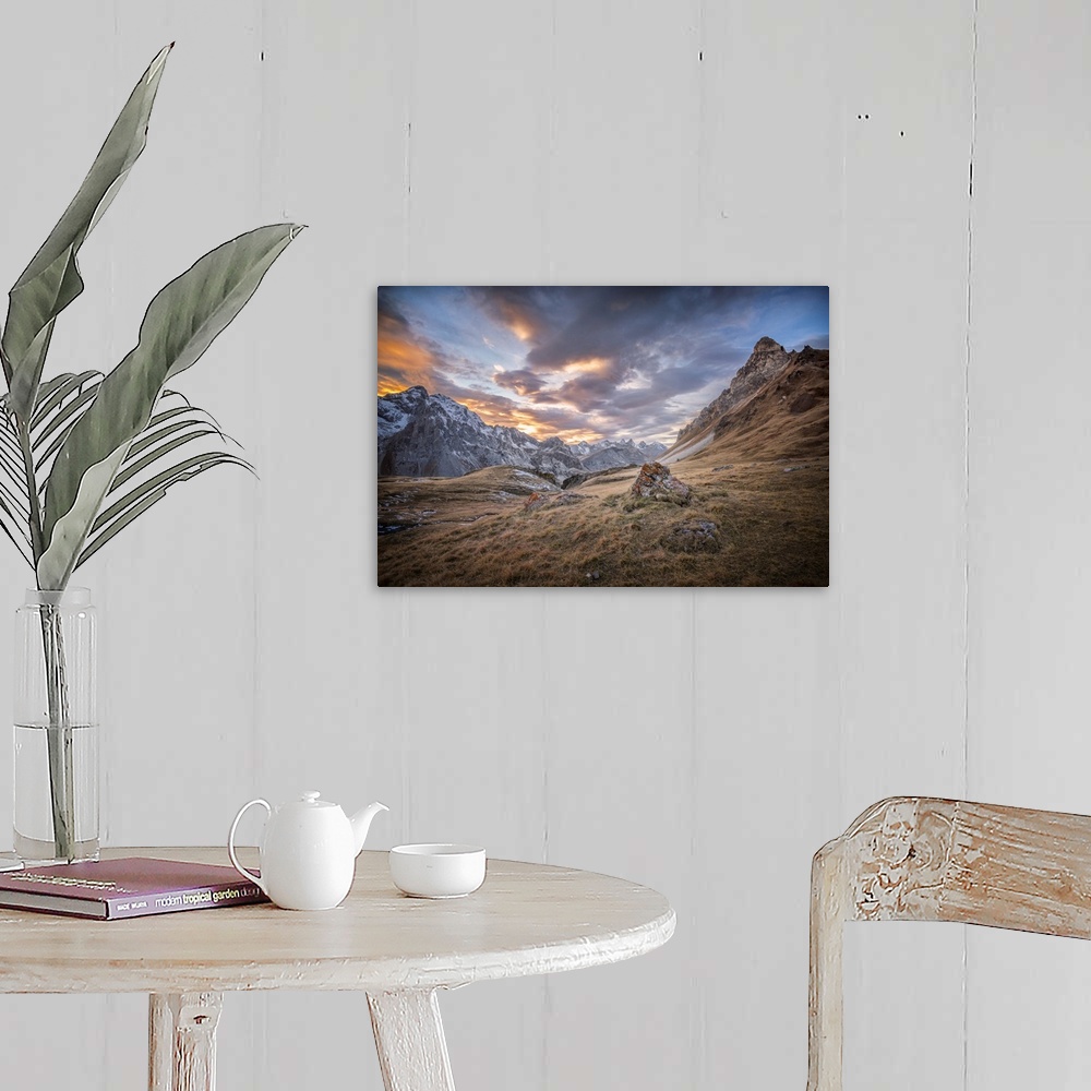 A farmhouse room featuring Fine art photograph of an alpine landscape with colorful clouds overhead.