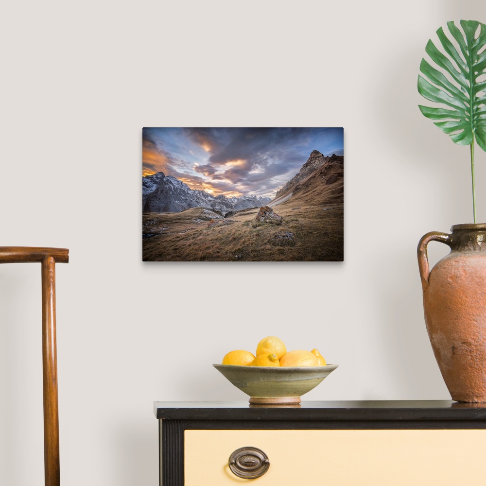 A traditional room featuring Fine art photograph of an alpine landscape with colorful clouds overhead.